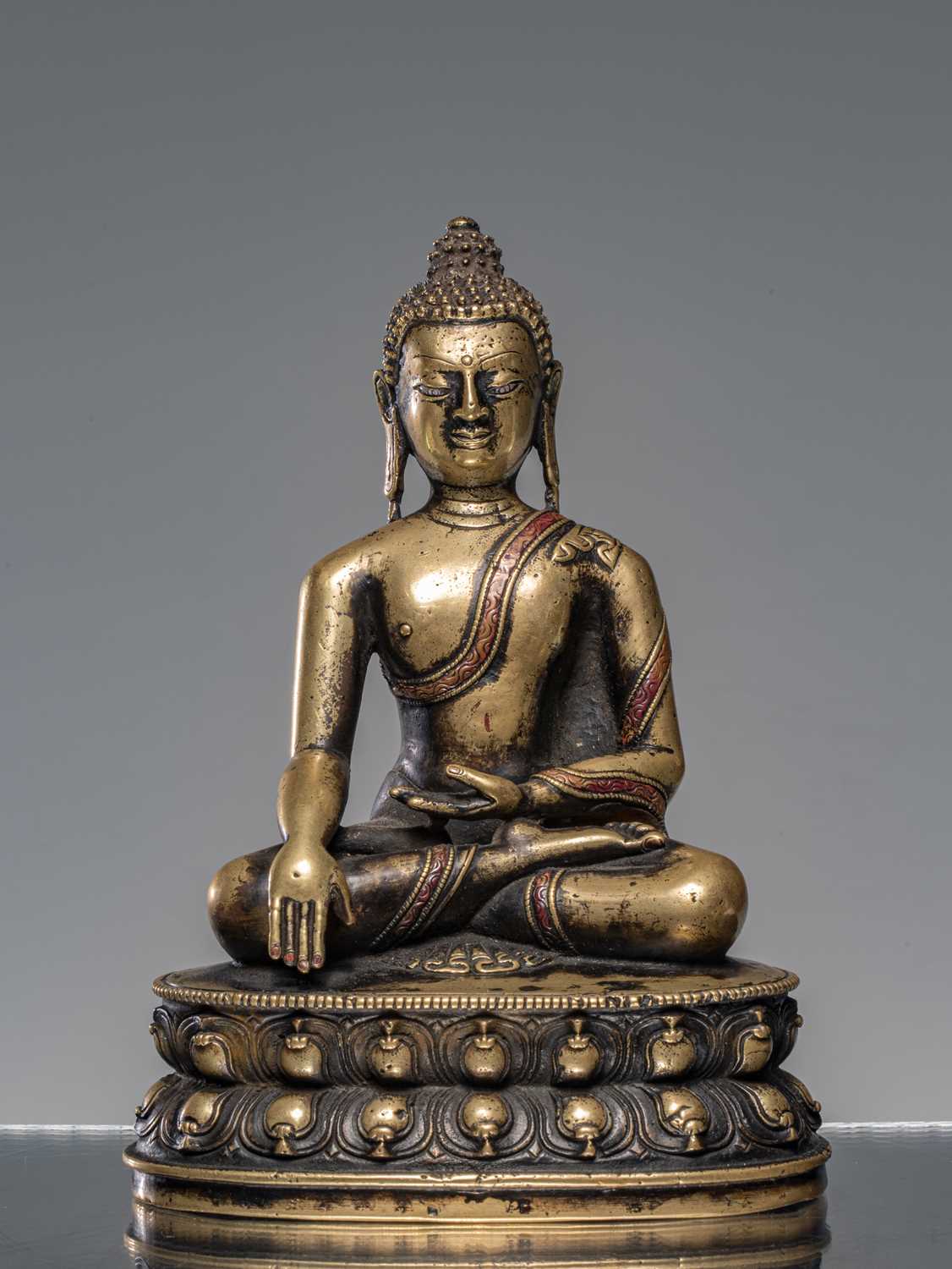 Lot 9 - A LARGE SILVER AND COPPER  INLAID BRONZE FIGURE OF SHAKYAMUNI BUDDHA, TIBET, 15TH CENTURY