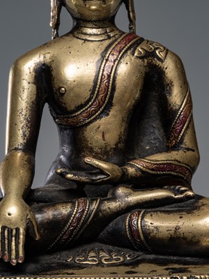 Lot 9 - A LARGE SILVER AND COPPER  INLAID BRONZE FIGURE OF SHAKYAMUNI BUDDHA, TIBET, 15TH CENTURY