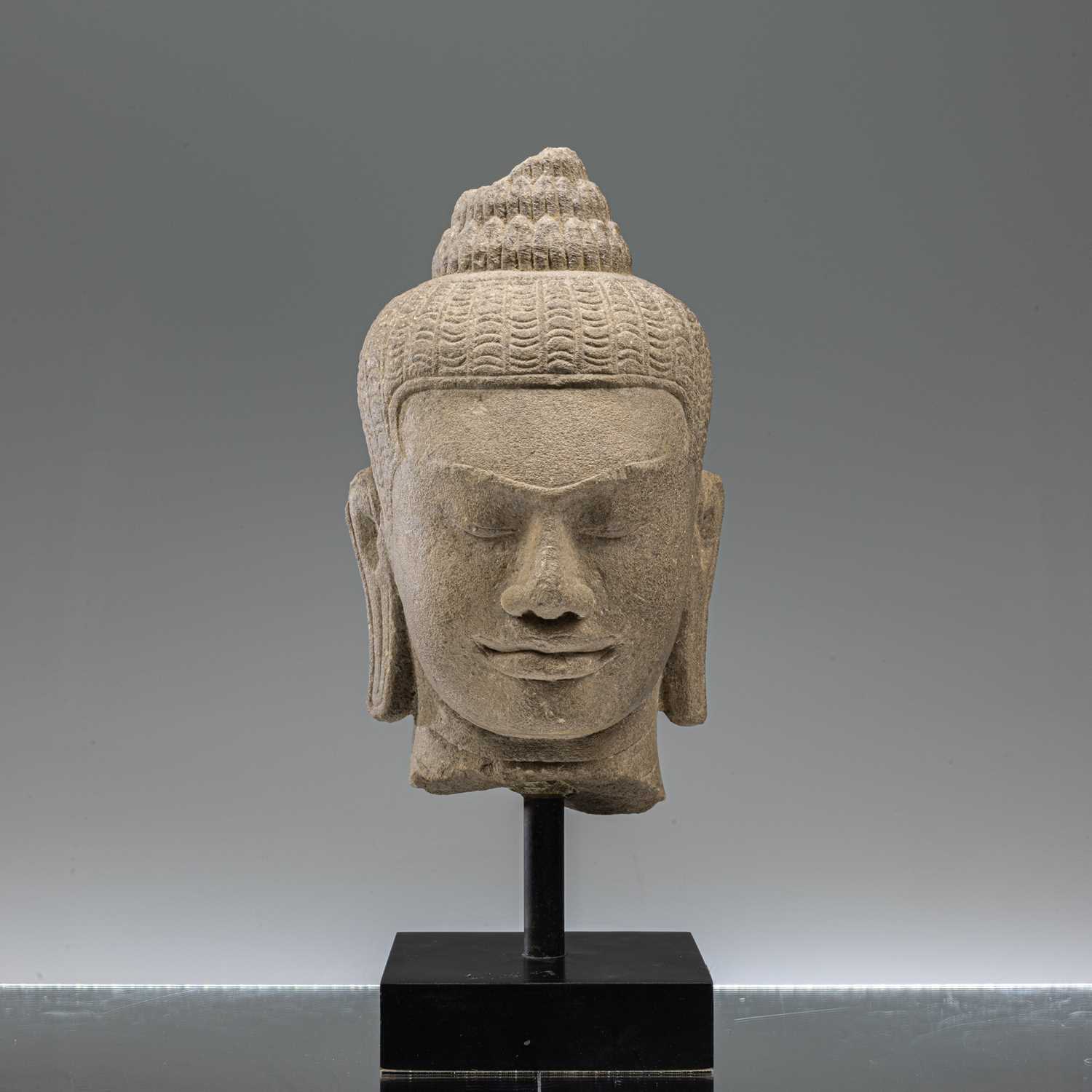 Lot 17 - SANDSTONE BAYON STYLE BUDDHA HEAD SOUTH-EAST ASIA 10TH CENTURY