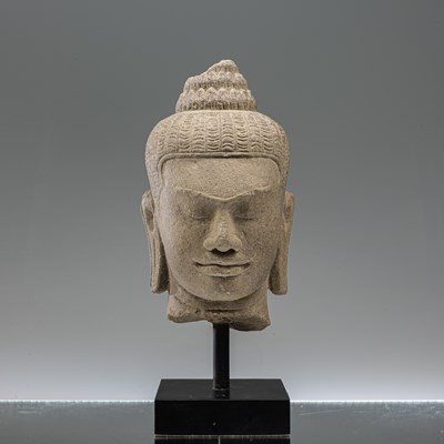 Lot 17 - SANDSTONE BAYON STYLE BUDDHA HEAD SOUTH-EAST ASIA 10TH CENTURY