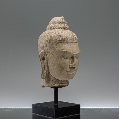 Lot 17 - SANDSTONE BAYON STYLE BUDDHA HEAD SOUTH-EAST ASIA 10TH CENTURY