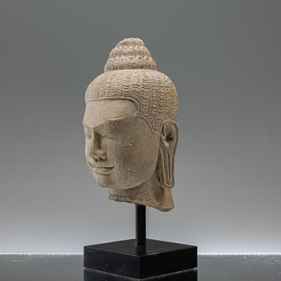 Lot 17 - SANDSTONE BAYON STYLE BUDDHA HEAD SOUTH-EAST ASIA 10TH CENTURY