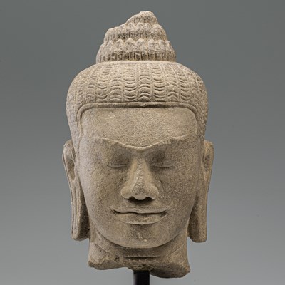 Lot 17 - SANDSTONE BAYON STYLE BUDDHA HEAD SOUTH-EAST ASIA 10TH CENTURY