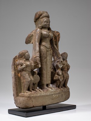 Lot 58 - LIME STONE SURYA WITH CONSORTS NEPAL 15TH CENTURY