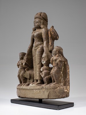 Lot 58 - LIME STONE SURYA WITH CONSORTS NEPAL 15TH CENTURY