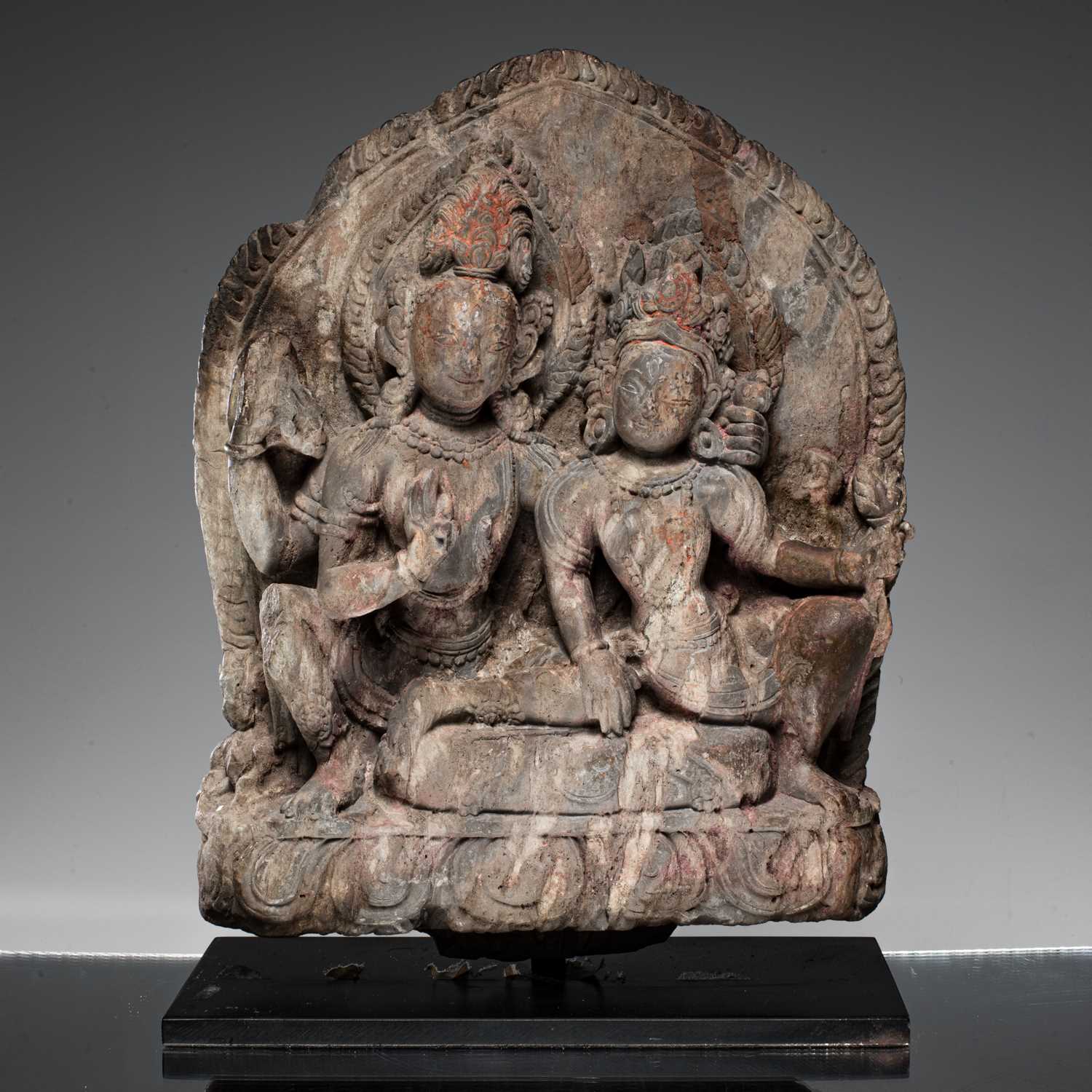Lot 55 - SHIVA AND PARVATI AS UMA MAHESVARA STONE NEPAL 18TH CENTURY