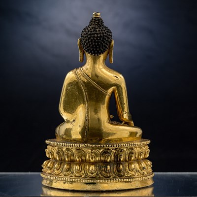 Lot 15 - SEATED BRONZE GILT AKSHOBYA BUDDHA TIBET 14TH CENTURY