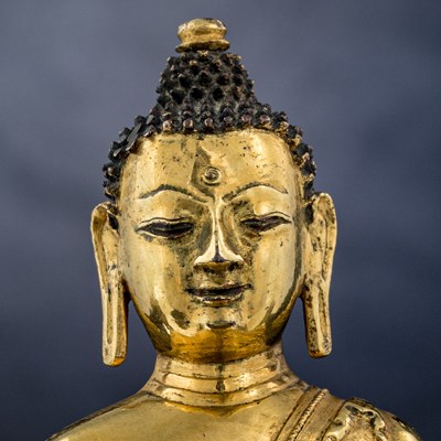 Lot 15 - SEATED BRONZE GILT AKSHOBYA BUDDHA TIBET 14TH CENTURY