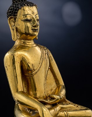Lot 15 - SEATED BRONZE GILT AKSHOBYA BUDDHA TIBET 14TH CENTURY
