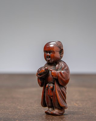 Lot 34 - (R) NETSUKE OF A BOY HOLDING A TORTOISE