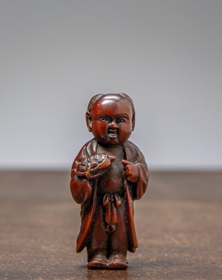 Lot 34 - (R) NETSUKE OF A BOY HOLDING A TORTOISE