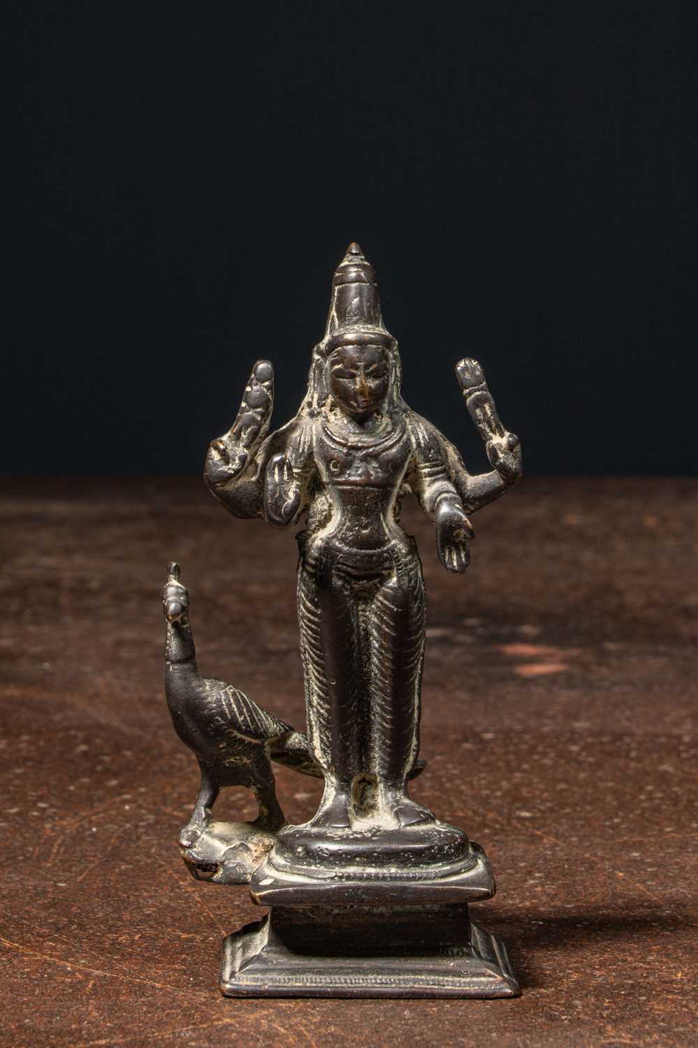 Lot 72 - A BRONZE FIGURE OF KARTIKEYA (SKANDA) WITH HIS VEHICLE PEACOCK NEPAL 19TH CENTURY