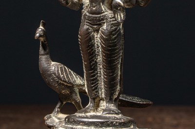 Lot 72 - A BRONZE FIGURE OF KARTIKEYA (SKANDA) WITH HIS VEHICLE PEACOCK NEPAL 19TH CENTURY