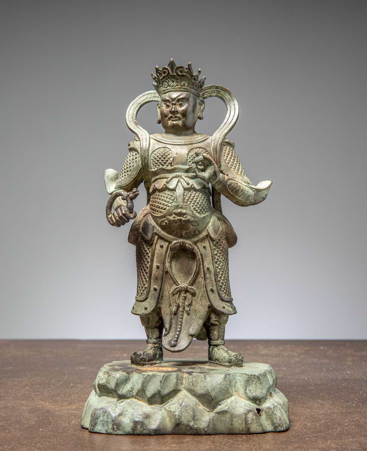 Lot 25 - A BRONZE FIGURE OF VIRŪPAKA, GUARDIAN KING OF THE WEST CHINA MING DYNASTY