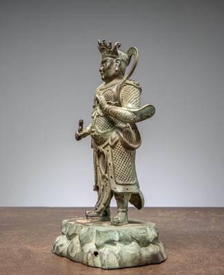 Lot 25 - A BRONZE FIGURE OF VIRŪPAKA, GUARDIAN KING OF THE WEST CHINA MING DYNASTY