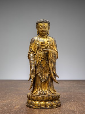 Lot 64 - A GILT-BRONZE BUDDHA HOLDING A VASE, CHINA LATE MINGY DYNASTY