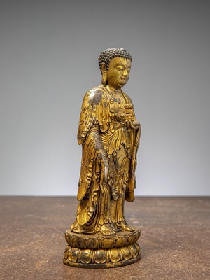 Lot 64 - A GILT-BRONZE BUDDHA HOLDING A VASE, CHINA LATE MINGY DYNASTY