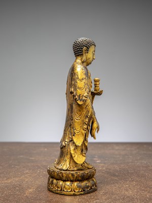 Lot 64 - A GILT-BRONZE BUDDHA HOLDING A VASE, CHINA LATE MINGY DYNASTY
