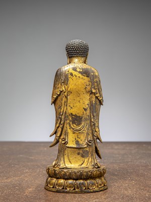 Lot 64 - A GILT-BRONZE BUDDHA HOLDING A VASE, CHINA LATE MINGY DYNASTY