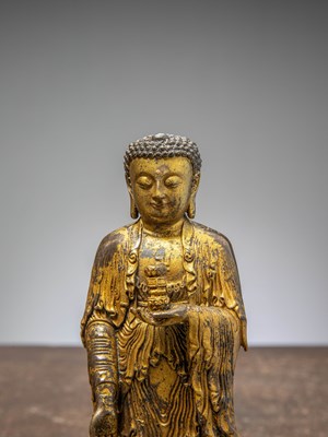 Lot 64 - A GILT-BRONZE BUDDHA HOLDING A VASE, CHINA LATE MINGY DYNASTY