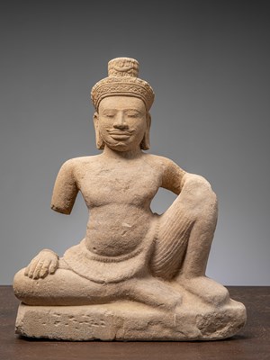 Lot 409 - A SEATED RARE FORM OF SHIVA, SANDSTONE, CAMBODIA, 10TH CENTURY, BAPHUON STYLE