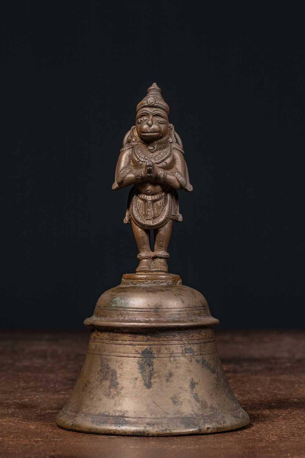 Lot 56 - STANDING BRONZE HANUMAN ON BELL INDIA 16TH CENTURY