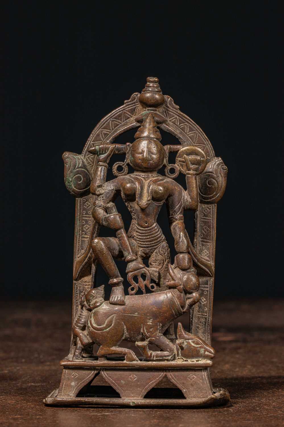 Lot 83 - A BRONZE FIGURE OF DURGA SLAYING THE BUFFALO DEMON (MAHIṢĀSURAMARDINĪ) INDIA 17TH CENTURY