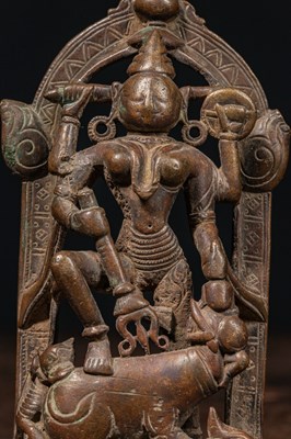 Lot 83 - A BRONZE FIGURE OF DURGA SLAYING THE BUFFALO DEMON (MAHIṢĀSURAMARDINĪ) INDIA 17TH CENTURY