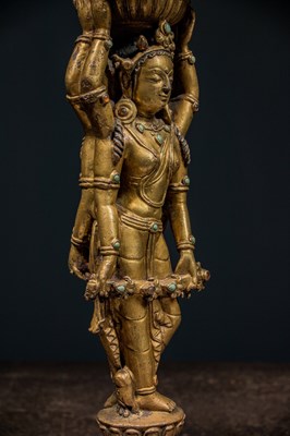 Lot 22 - A GILT-BRONZE DOUBLE-SIDED OFFERING GODDESS FROM A DENSATIL MONASTERY PILLAR TIBET 14TH CENTURY