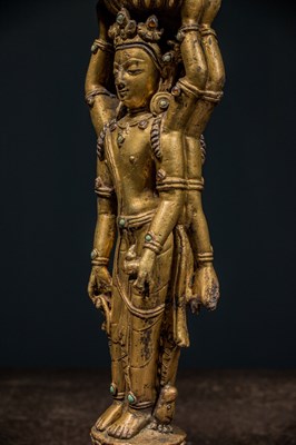 Lot 22 - A GILT-BRONZE DOUBLE-SIDED OFFERING GODDESS FROM A DENSATIL MONASTERY PILLAR TIBET 14TH CENTURY