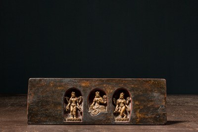 Lot 182 - A WOOD BOOK COVER WITH THREE DIVINE FIGURES TIBET 17TH CENTURY