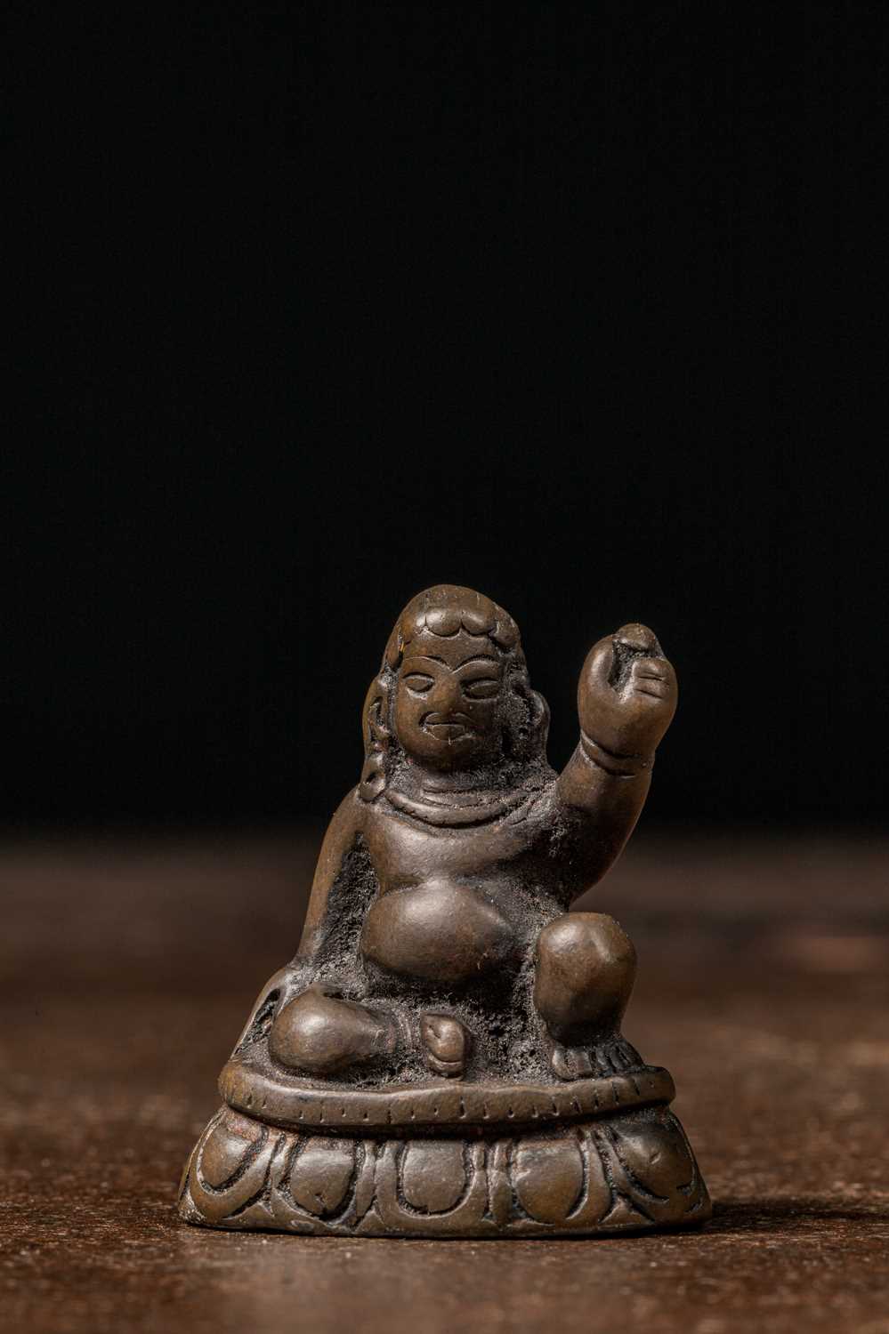 Lot 73 - A MINIATURE BRONZE FIGURE OF A MAHASIDDHA, PROBABLY VIRŪPA TIBET 13TH CENTURY