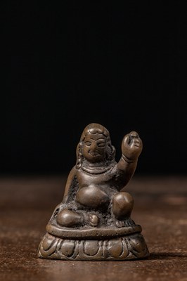 Lot 73 - A MINIATURE BRONZE FIGURE OF A MAHASIDDHA, PROBABLY VIRŪPA TIBET 13TH CENTURY