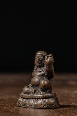 Lot 73 - A MINIATURE BRONZE FIGURE OF A MAHASIDDHA, PROBABLY VIRŪPA TIBET 13TH CENTURY