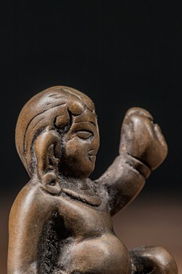 Lot 73 - A MINIATURE BRONZE FIGURE OF A MAHASIDDHA, PROBABLY VIRŪPA TIBET 13TH CENTURY