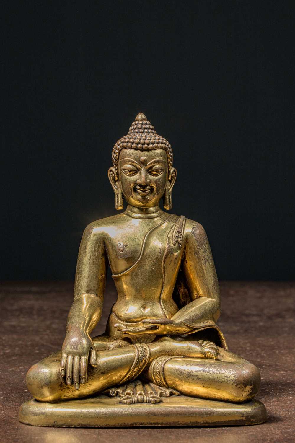Lot 80 - A GILT BRONZE FIGURE OF BUDDHA IN PĀLA REVIVAL STYLE TIBET 18TH CENTURY