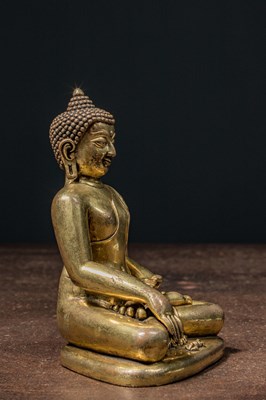 Lot 80 - A GILT BRONZE FIGURE OF BUDDHA IN PĀLA REVIVAL STYLE TIBET 18TH CENTURY