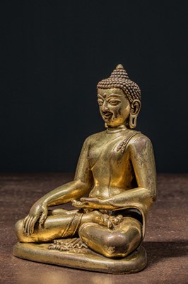 Lot 80 - A GILT BRONZE FIGURE OF BUDDHA IN PĀLA REVIVAL STYLE TIBET 18TH CENTURY