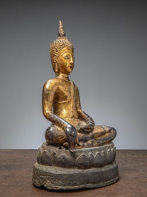 Lot 58 - (R) A GILT BRONZE FIGURE OF BUDDHA ON A LATER INSCRIBED BASE, THAILAND AYUTTHYA (1600 - 1650)