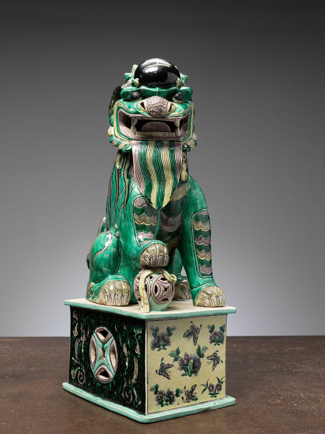Lot 7 - (R) A RARE AND IMPRESSIVE SANCAI-GLAZED POTTERY FIGURE OF A BUDDHIST LION CHINA QING DYNASTY