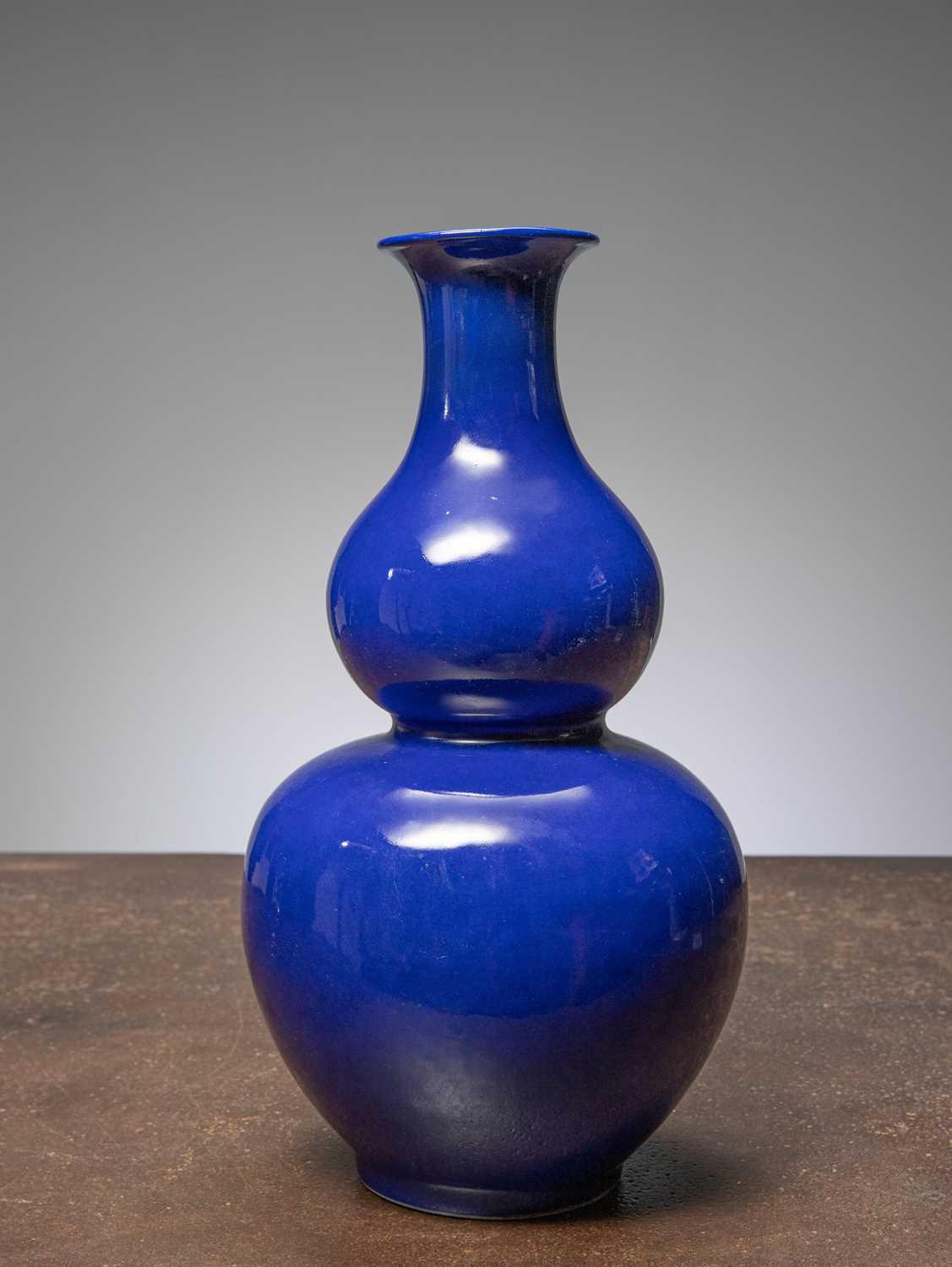 Lot 82 - (R) A MONOCHROME COBALT-BLUE DOUBLE GOURD VASE, CHINA, QING DYNASTY WITH QIANLONG MARK