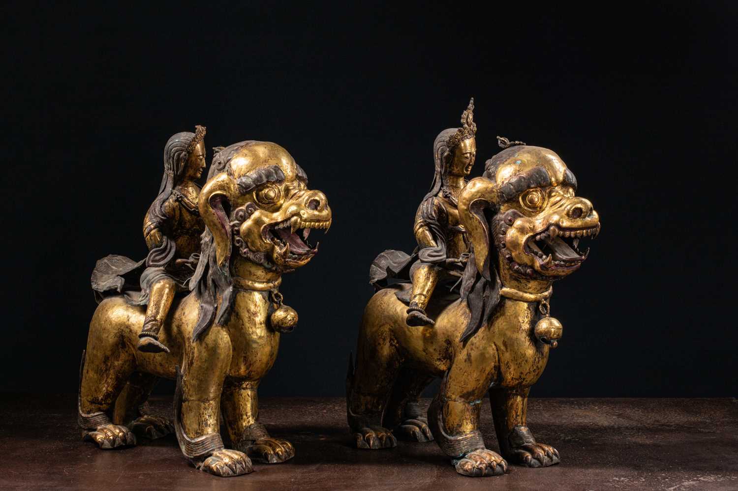 Lot 45 - (R) PAIR OF COPPER REPOUSSE GILT TEMPLE GUARDS ON FO-DOGS SINO-TIBETAN 17TH /18TH CENTURY