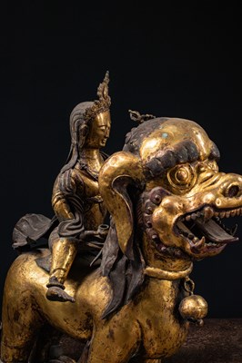 Lot 45 - (R) PAIR OF COPPER REPOUSSE GILT TEMPLE GUARDS ON FO-DOGS SINO-TIBETAN 17TH /18TH CENTURY