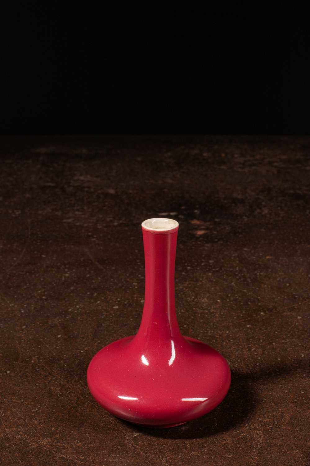 Lot 94 - (R) SMALL BULBOUS LONG-NECK VASE BRICK RED GLAZE, QING DYNASTY CHINA