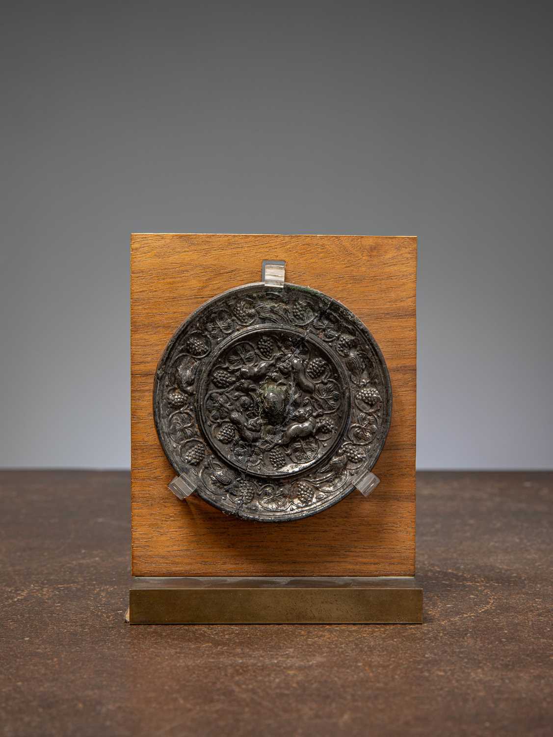 Lot 74 - (R) A BRONZE MIRROR WITH ANIMALS AND GRAPEVINES, TANG DYNASTY, CHINA 7TH TO 8TH CENTURY