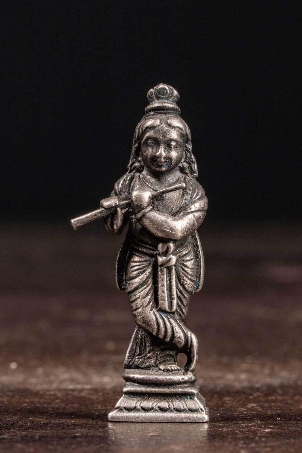 Lot 53 - (R) A SILVER FIGURE OF STANDING KRISHNA PLAYING THE FLUTE INDIA 19TH CENTURY