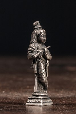 Lot 53 - (R) A SILVER FIGURE OF STANDING KRISHNA PLAYING THE FLUTE INDIA 19TH CENTURY
