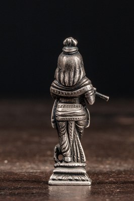 Lot 53 - (R) A SILVER FIGURE OF STANDING KRISHNA PLAYING THE FLUTE INDIA 19TH CENTURY