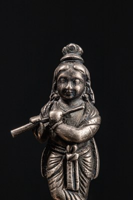 Lot 53 - (R) A SILVER FIGURE OF STANDING KRISHNA PLAYING THE FLUTE INDIA 19TH CENTURY