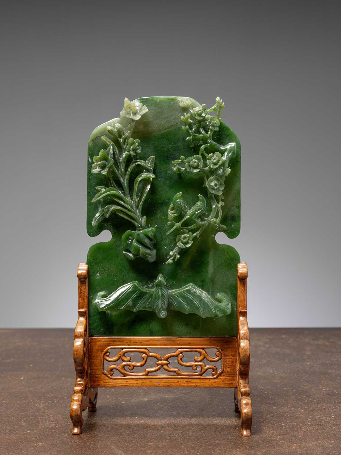 Lot 50 - (R) A GREEN JADE SCREEN WITH BAT, FLOWERS, AND BIRDS QING DYNASTY (1644-1911) China